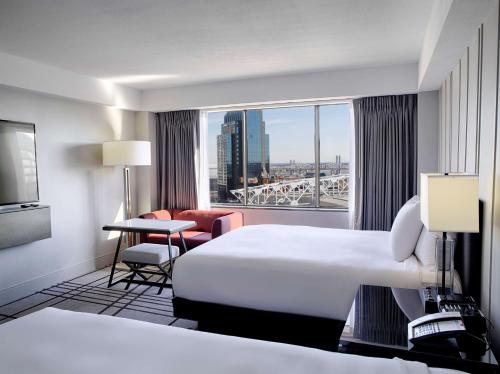 a hotel room with a bed and a large window at Hyatt Regency Louisville in Louisville