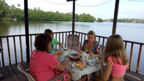 a group of women sitting at a table eating food at Mahi Villa in Bentota