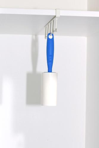 a blue toothbrush in a holder hanging from a wall at Gwanganli Hotel 1 in Busan