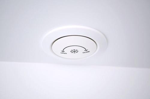 a white ceiling light with a white wall at Gwanganli Hotel 1 in Busan