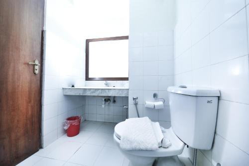a bathroom with a toilet and a sink and a mirror at Samsara Boutique Hotel in Kathmandu