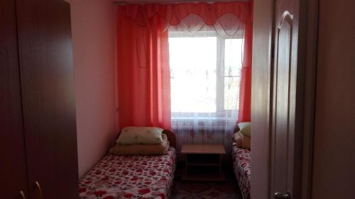ジヴェエヴォにあるDiveevskoe podvorieの窓と小さなベッドが備わる小さな客室です。