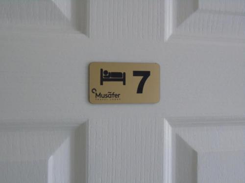 a sign on a door with the number on it at The Musafer Travel Lodge in Pietermaritzburg