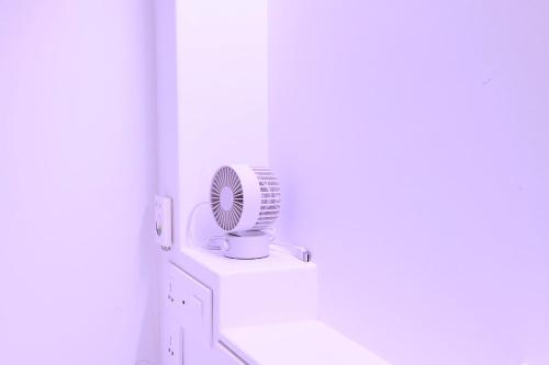 a white room with a fan on a counter at Gwanganli Hotel 1 in Busan