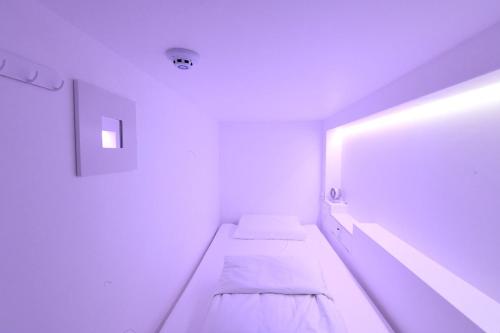 a white room with two beds in it at Gwanganli Hotel 1 in Busan