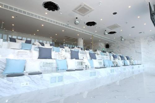 a room with blue and white pillows on display at Gwanganli Hotel 1 in Busan