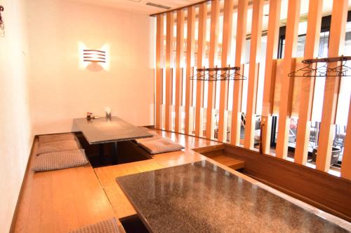 a living room with a table and a large window at Chitose Airport Hotel in Chitose
