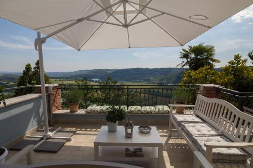 a patio with a white umbrella and a table at La Valle del Tevere in Torrita Tiberina