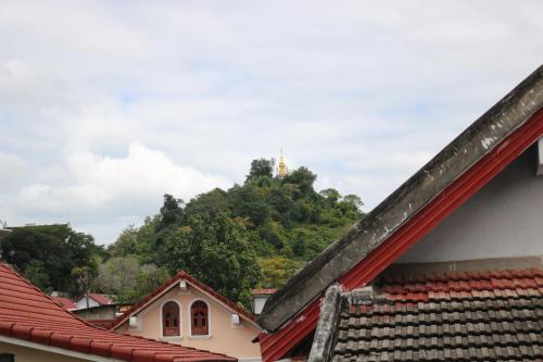 a view from the roofs of houses with a mountain in the background at Jasmine Luangprabang Hotel in Luang Prabang