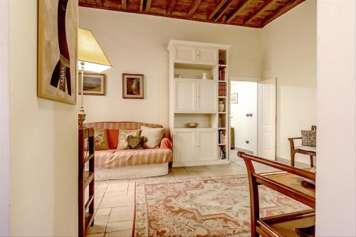 a living room with a couch and a table at Palazzo Farnese Historical Home in Rome