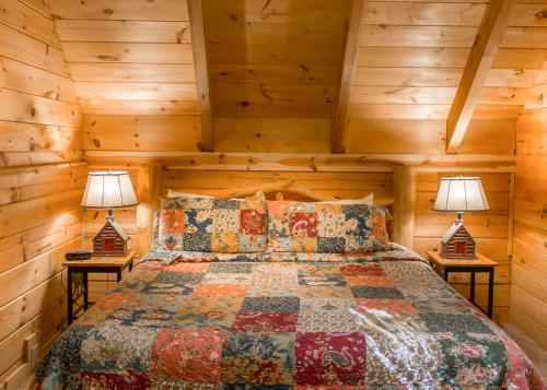 a bedroom with a bed in a log cabin at Mountain Dreams #24 in Sevierville
