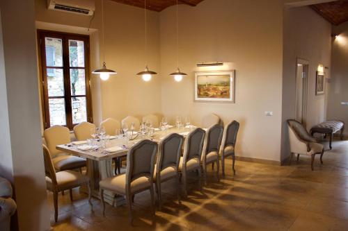 a dining room with a long table and chairs at Borgo Argiano in Castelnuovo Berardenga
