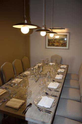 a long table with glasses and napkins on it at Borgo Argiano in Castelnuovo Berardenga