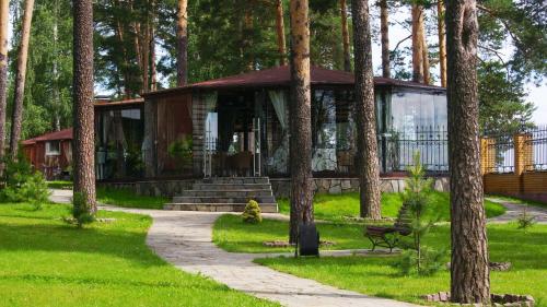 a house in the middle of a park with trees at Park-hotel in Perm