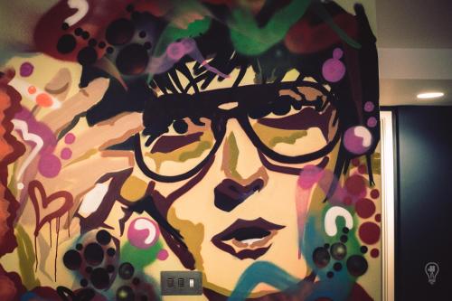 a painting of a woman wearing glasses at Jonas Hotel in Sheffield