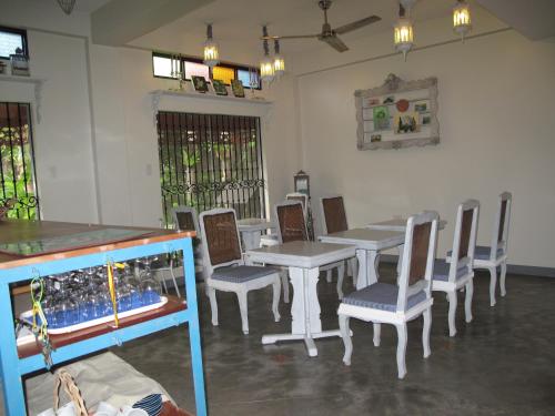 a dining room with a table and chairs at Casita Aurora Bed and Breakfast in Legazpi