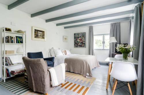 a bedroom with a bed and a table and chairs at The Pool House in Den Dolder