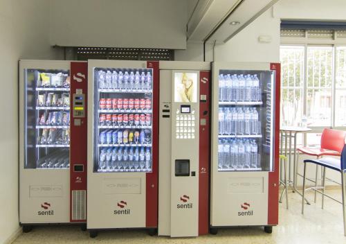 a row of soda vending machines in a store at Albergue Inturjoven Malaga in Málaga