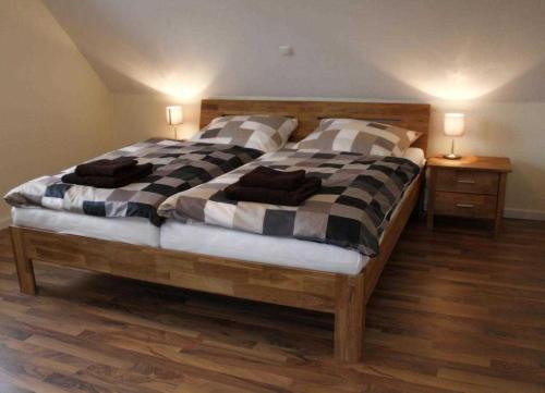 a bedroom with a large bed with pillows on it at Ferienhaus Strandperle in Garrel