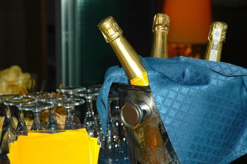 a bottle of champagne sitting on a table with glasses at Hotel Mec in Milan