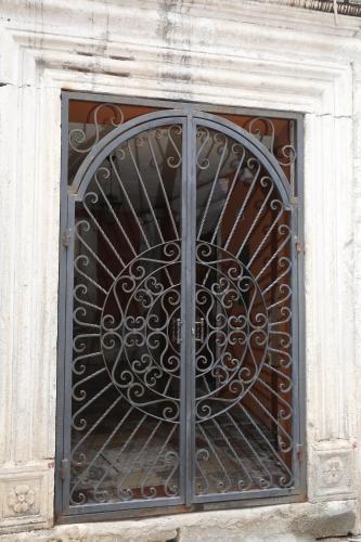 a iron gate on the side of a building at Old town Kotor Square in Kotor