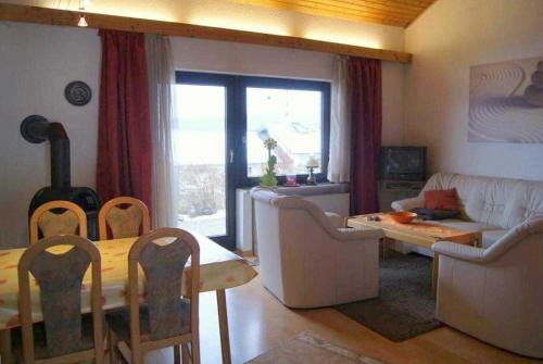 a living room with a couch and a table with chairs at Ferienhaus Meike im Naturpark Bayr in Zandt