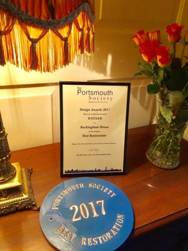 a plaque sitting on a table with a sign at Ye Spotted Dogge in Portsmouth