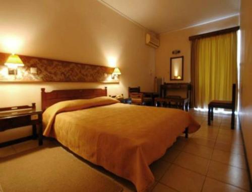 a hotel room with a large bed in a room at Zikas Hotel in Preveza