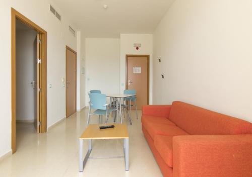 a living room with a couch and a table at Albergue Inturjoven Jaen in Jaén