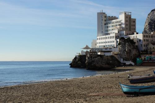 
a boat sitting on top of a sandy beach at The Caleta Hotel Health, Beauty & Conference Centre in Gibraltar
