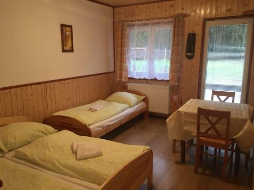 A bed or beds in a room at Pension Peklo