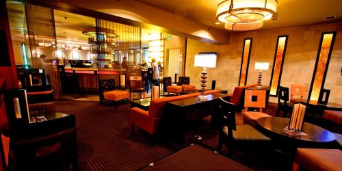 a restaurant with couches and tables and a bar at Mirabeau Park Hotel in Spokane Valley