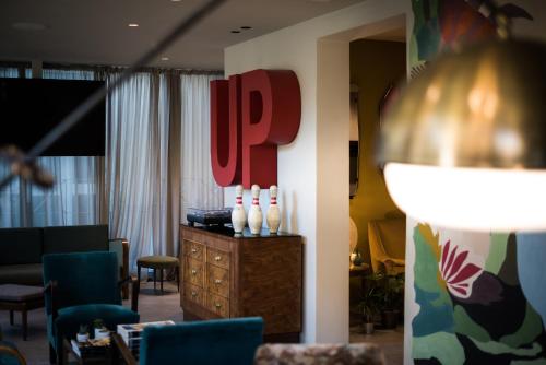 a lobby with a waiting room with chairs and a table at Up Hotel in Rimini