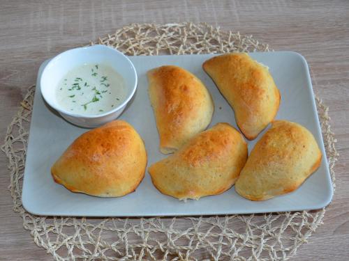 a plate with five rolls and a bowl of dipping sauce at Młynarzowa Chata in Lesko