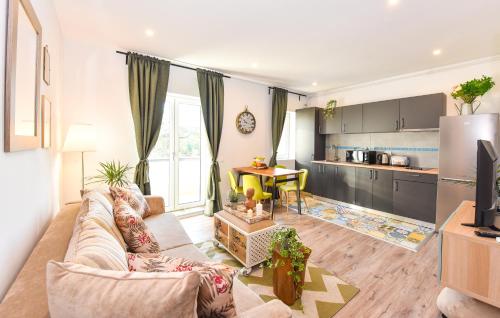 a living room with a couch and a kitchen at Parliament & River View Apartments in Bucharest