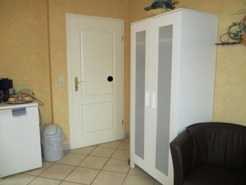 a room with a white door and a kitchen at Behrs Hof in Scharmbeck