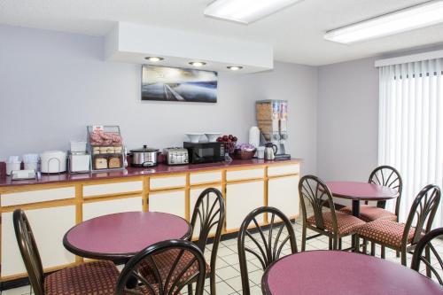a dining room with purple tables and chairs at Super 8 by Wyndham Springdale AR in Springdale