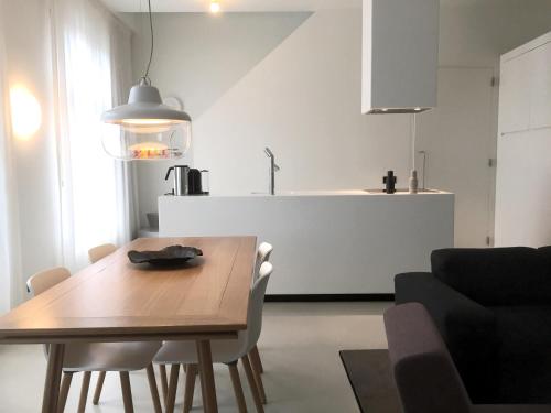 a living room filled with furniture and a table at Urban Residences Maastricht in Maastricht