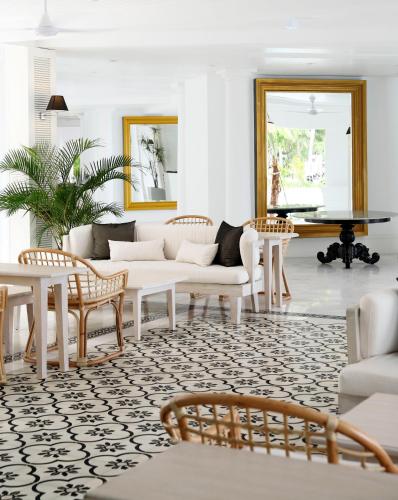 a living room with white furniture and a table at Nongsa Point Marina in Nongsa