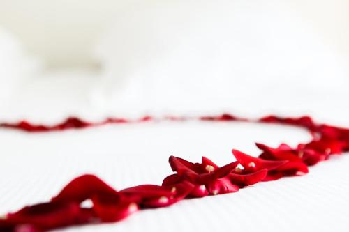 a red bow tie sitting on a white table at Hôtel Montaigne & Spa - Cannes Centre in Cannes