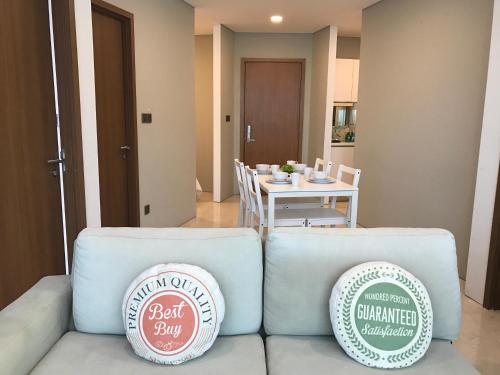 a living room with a couch and a table at VORTEX SUITES KLCC by PNUT With NETFLIX in Kuala Lumpur