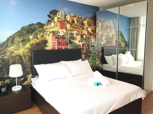 a bedroom with two beds with a painting on the wall at VORTEX SUITES KLCC by PNUT With NETFLIX in Kuala Lumpur