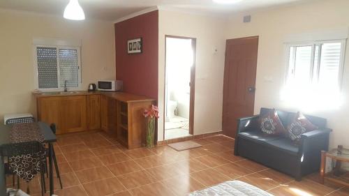 a living room with a couch and a kitchen at VIP House-Praia Francesca in São Tomé