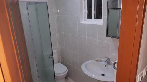 a bathroom with a toilet and a sink at VIP House-Praia Francesca in São Tomé