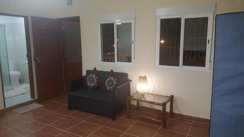 a living room with a couch and a table at VIP House-Praia Francesca in São Tomé