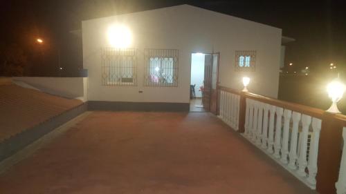 a hallway of a house at night with lights at VIP House-Praia Francesca in São Tomé