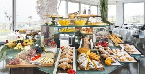 a buffet with many different types of food on display at Gran Paradiso Hotel Spa in San Giovanni Rotondo