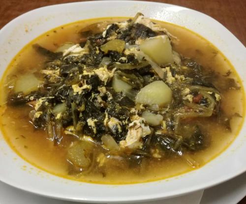 a bowl of soup on a plate on a table at Hotel Relais Valle Orientina in Pitigliano