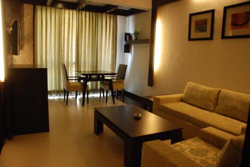 a living room with a couch and a table at Le Magnifique in Porvorim