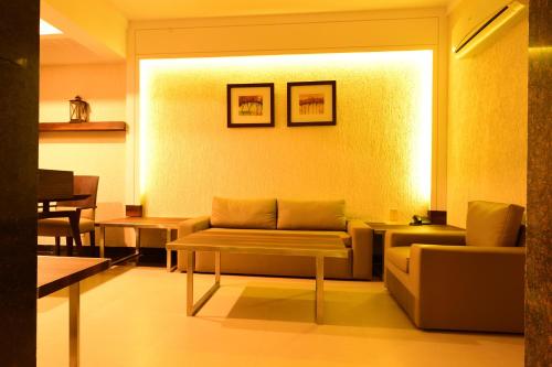 a living room with a couch and a table at Le Magnifique in Porvorim